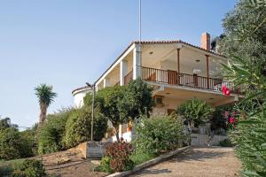 a house with a balcony on the side of it at Villa Sugar Town in Zacharo