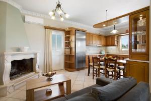a kitchen and living room with a couch and a fireplace at Christine's House in Zakynthos