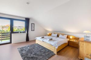 a bedroom with a bed and a large window at Ferienwohnung Obrighoven in Wesel