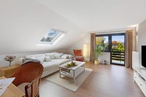 a living room with a white couch and a table at Ferienwohnung Obrighoven in Wesel