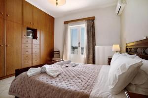 a bedroom with a large bed with towels on it at Christine's House in Zakynthos +24 photos