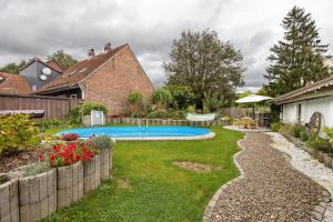 a backyard with a swimming pool in a yard at Gruppenhaus Osterhagen in Bad Lauterberg