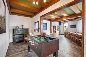 a room with a foosball table and a piano at Gruppenhaus Osterhagen in Bad Lauterberg