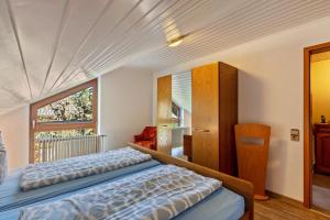 a bedroom with a bed and a window at Kirschenhof in Bad Bellingen