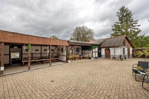 a building with a pavilion and a patio at Gruppenhaus Osterhagen in Bad Lauterberg
