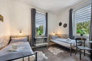 a bedroom with two beds and a window at Gruppenhaus Osterhagen in Bad Lauterberg +24 photos
