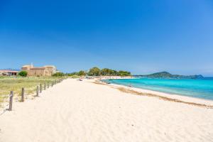 a beach with people sitting on the sand and the water at Luxury Guesthouse Pula in Pula