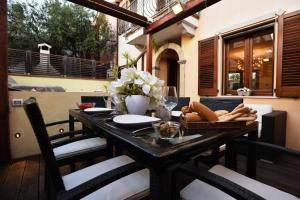 a wooden table with a tray of bread on a balcony at Luxury Guesthouse Pula in Pula