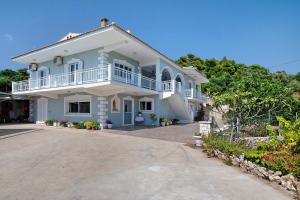 a large white house with a large driveway at Christine's House in Zakynthos