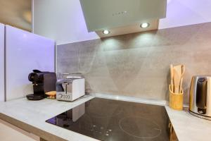 a kitchen with a counter top with a coffee maker at Le Voltaire pour 4 in Sète +17 photos