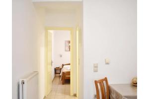 a hallway with a table and a dining room at Manolika Studio 1 in Kithnos