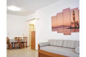 a living room with a couch and a table at Manolika Studio 1 in Kithnos