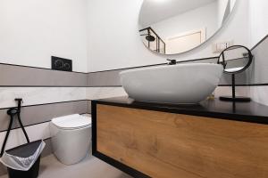 a bathroom with a white sink and a mirror at Lake Como - Incanto in Valvarrone +30 photos