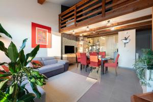 a living room with a couch and a dining room at Lake Como - Incanto in Valvarrone