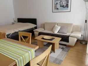 a living room with a couch and a table at Schloss Grubhof Appartement in Sankt Martin bei Lofer