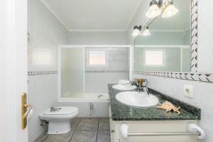 a white bathroom with a sink and a toilet at Costa den Blau in Porto Cristo +17 photos