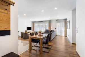 a dining room and living room with a table and chairs at Ferienwohnung Sophie Stecker in Schmallenberg