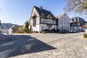 a large house on a street with a road at Ferienwohnung Sophie Stecker in Schmallenberg