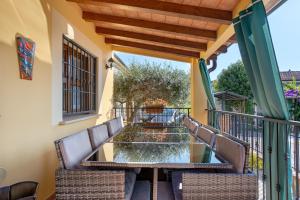 a balcony with a table and chairs on it at Villa Gardenia - Private Garden in Sarzana