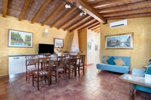 a kitchen and dining room with a table and chairs at Villa Gardenia - Private Garden in Sarzana