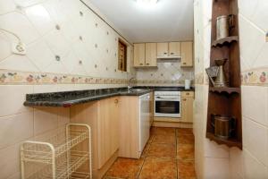 a kitchen with wooden cabinets and a dishwasher at El Molino del pepe in Almajano +14 photos