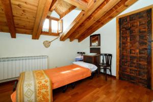 a bedroom with a bed and a desk in a room at El Molino del pepe in Almajano