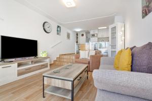 a living room with a couch and a tv at Casa Lotti With Ocean View in Santa Cruz de Tenerife
