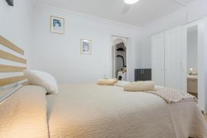 a white bedroom with a large bed with two pillows on it at Casa Lotti With Ocean View in Santa Cruz de Tenerife +22 photos