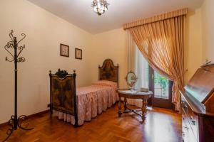a bedroom with a bed and a piano at The Rosa's Luxury House in Alezio +25 photos