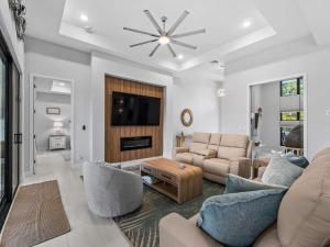 a living room with a couch and a tv at Waterfront Haven with Pool Spa Game Room in Port Charlotte +56 photos