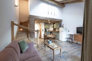 a living room with a couch and a table at Les Petits Loups in Morillon