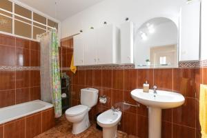 a bathroom with a toilet and a sink and a tub at Arenas de Sal in La Mareta +18 photos