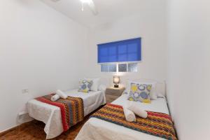 a bedroom with two beds and a window at Arenas de Sal in La Mareta