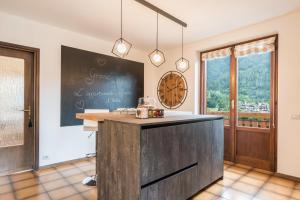 a large kitchen with a blackboard and a counter at Casa Facco in Bocenago +35 photos