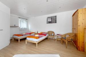 a room with two beds and a table and chairs at Felsenburg in Ahrenviölfeld
