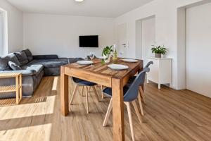 a kitchen and living room with a wooden table and chairs at Stegmann Horn in Gaienhofen