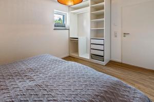 a bedroom with a bed and a walk in closet at Stegmann Horn in Gaienhofen