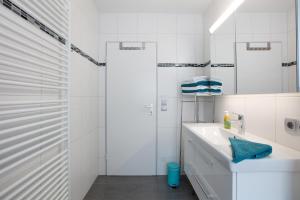 a white bathroom with a sink and a shower at Ferienwohnung Barbara in Karsau +13 photos
