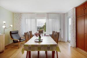 a dining room with a table with flowers on it at Ferienwohnung Barbara in Karsau