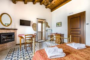 a bedroom with two beds and a fireplace at Arcaloro Resort Rooms in SantʼAngelo di Brolo