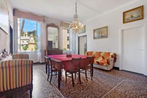 a dining room with a red table and chairs at Piazza 100 Croci in Bonassola