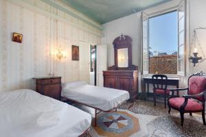 a bedroom with two beds and a desk and a chair at Piazza 100 Croci in Bonassola
