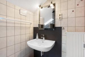 a bathroom with a sink and a mirror at Ferienwohnung Lux in Plettenberg +17 photos