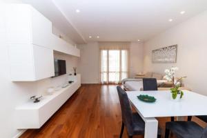a kitchen and living room with a white table and chairs at La Dimora del Benessere in Noicattaro
