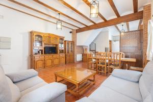 a living room with a couch and a table at Cueva De La Portería in Chulilla +15 photos
