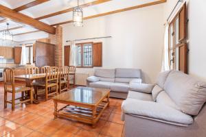 a living room with a couch and a table at Cueva De La Portería in Chulilla