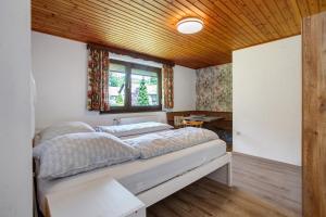 a bedroom with a bed in a room with a window at Am Wehrastrand App Pr in Todtmoos