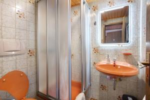 a bathroom with a sink and a shower and a toilet at Am Wehrastrand App Pr in Todtmoos