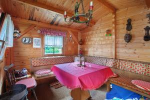 a dining room with a table and chairs in a cabin at Am Wehrastrand App Pr in Todtmoos
