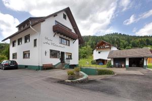 a building with a car parked in front of it at Am Wehrastrand App Pr in Todtmoos